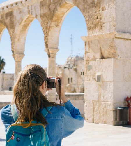 Woman Taking Pictures of Ruins